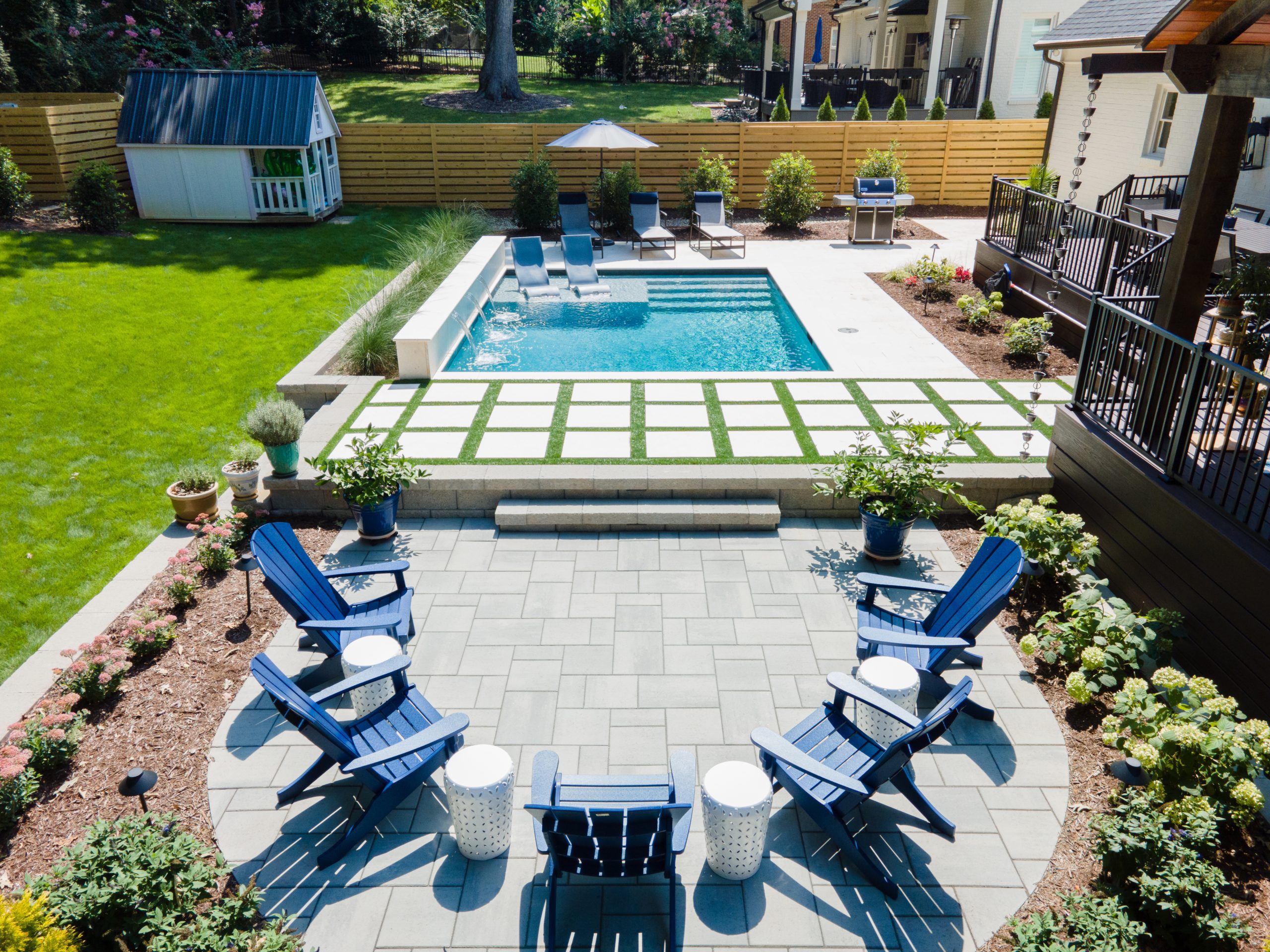 Patio, landscaping, pool with waterfall