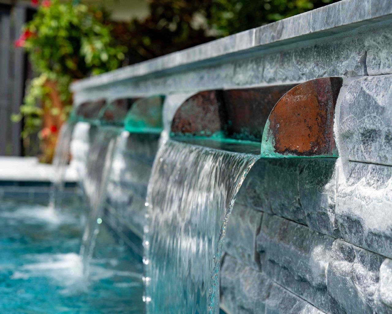 a custom swimming pool water feature